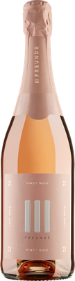 Eine elegante Flasche Rosé-Sekt mit einem zarten, rosafarbenen Etikett und dem Schriftzug 'Freunde' in stilvollem Design.