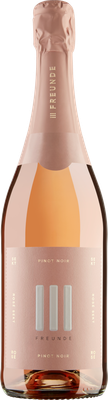 Eine elegante Flasche Rosé-Sekt mit einem zarten, rosafarbenen Etikett und dem Schriftzug 'Freunde' in stilvollem Design.